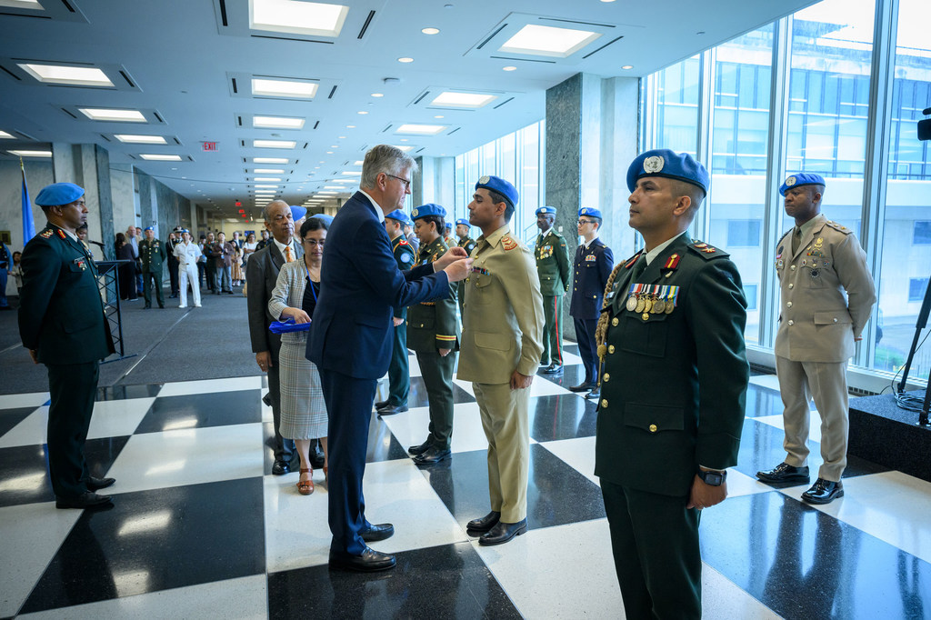 Jean-Pierre Lacroix, Under-Secretary-General for Peace Operations, presents medals during the Peacekeeping Military Police Medal Award Ceremony on the International Day of UN Peacekeepers.
